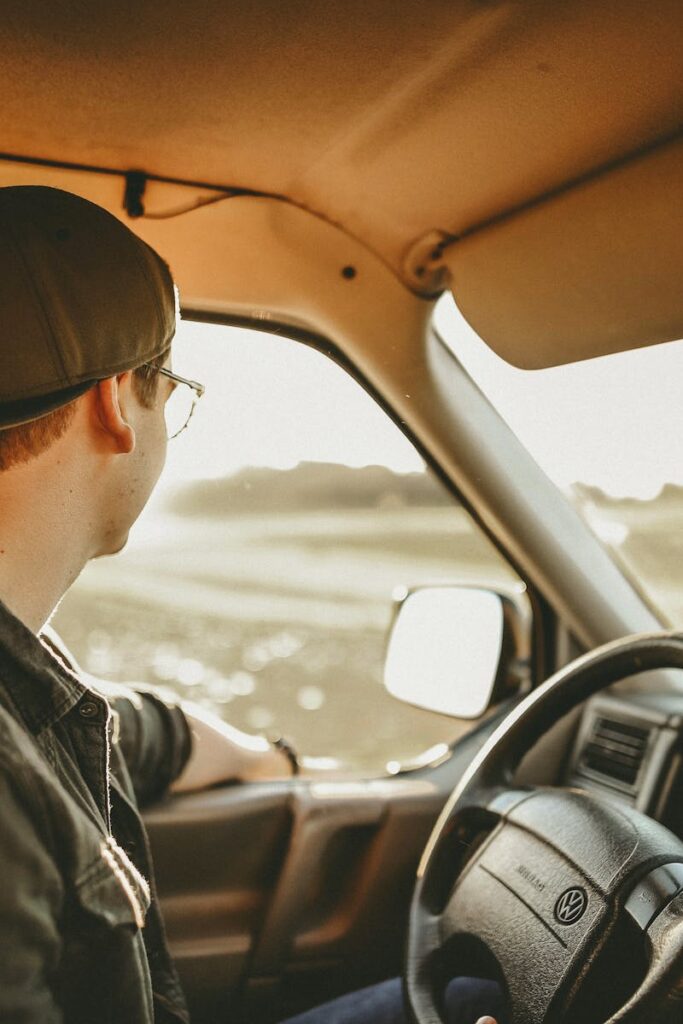 pexels photo 620332 620332 A man enjoys a relaxed drive through the countryside on a sunny day, looking out onto the scenery.